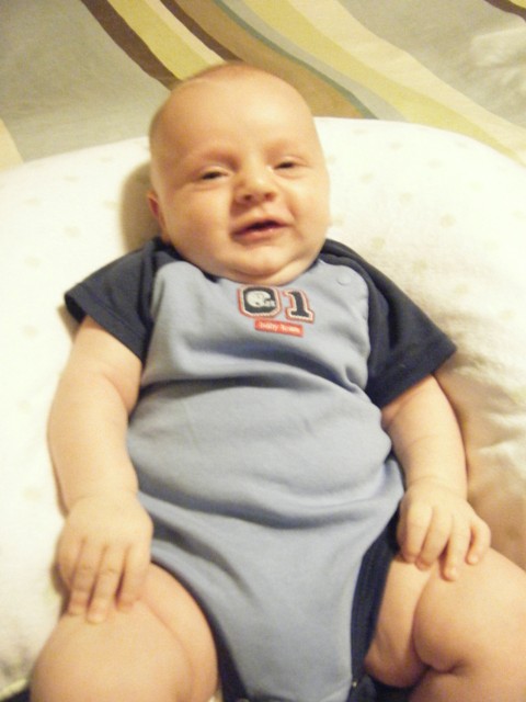 Smiling in a new onesie from Matt's parents