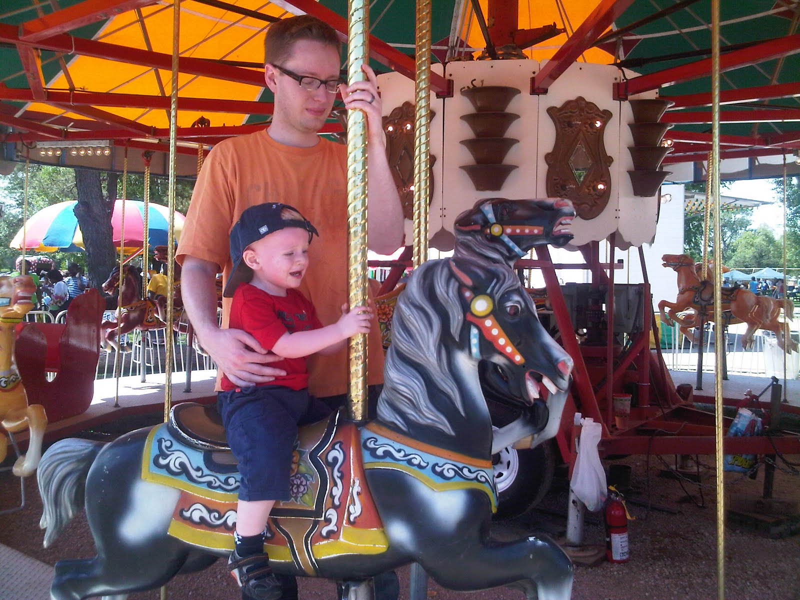 Carousel at Heman Park UCity Fair. When it stopped Andy said "horsey again"