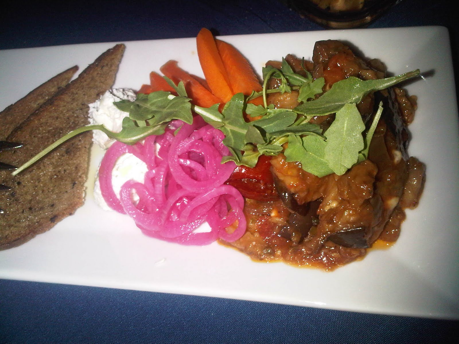 Antipasti of lemon goat cheese eggplant tapenade pickled carrots and onions