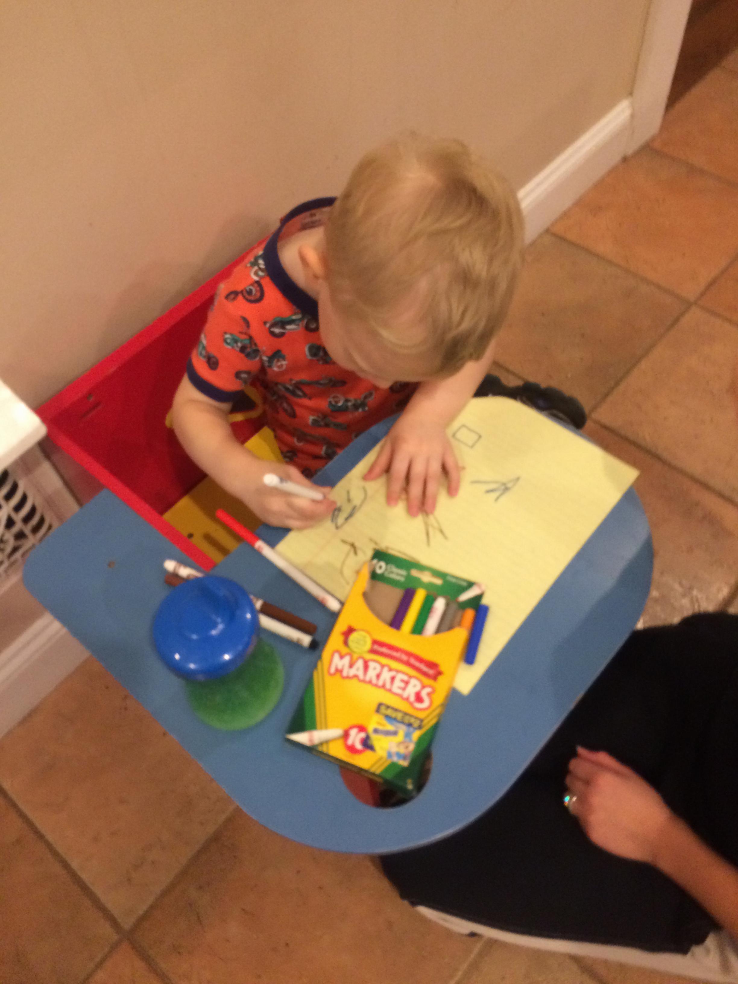Charlie holds a pen like an adult. Look at that grip