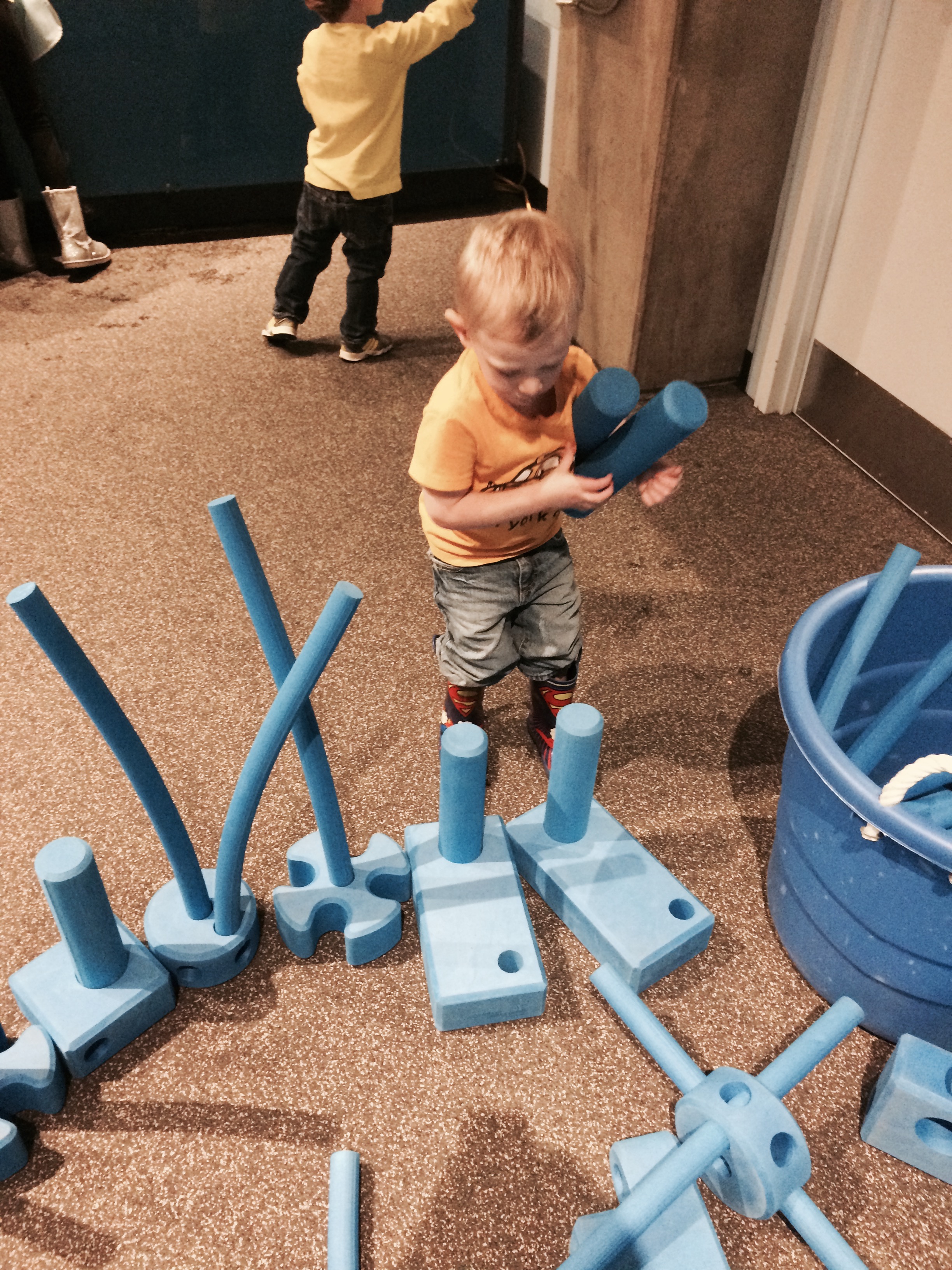 Industrious Charlie in discovery room lined up the pieces and put tubes in wholes himself