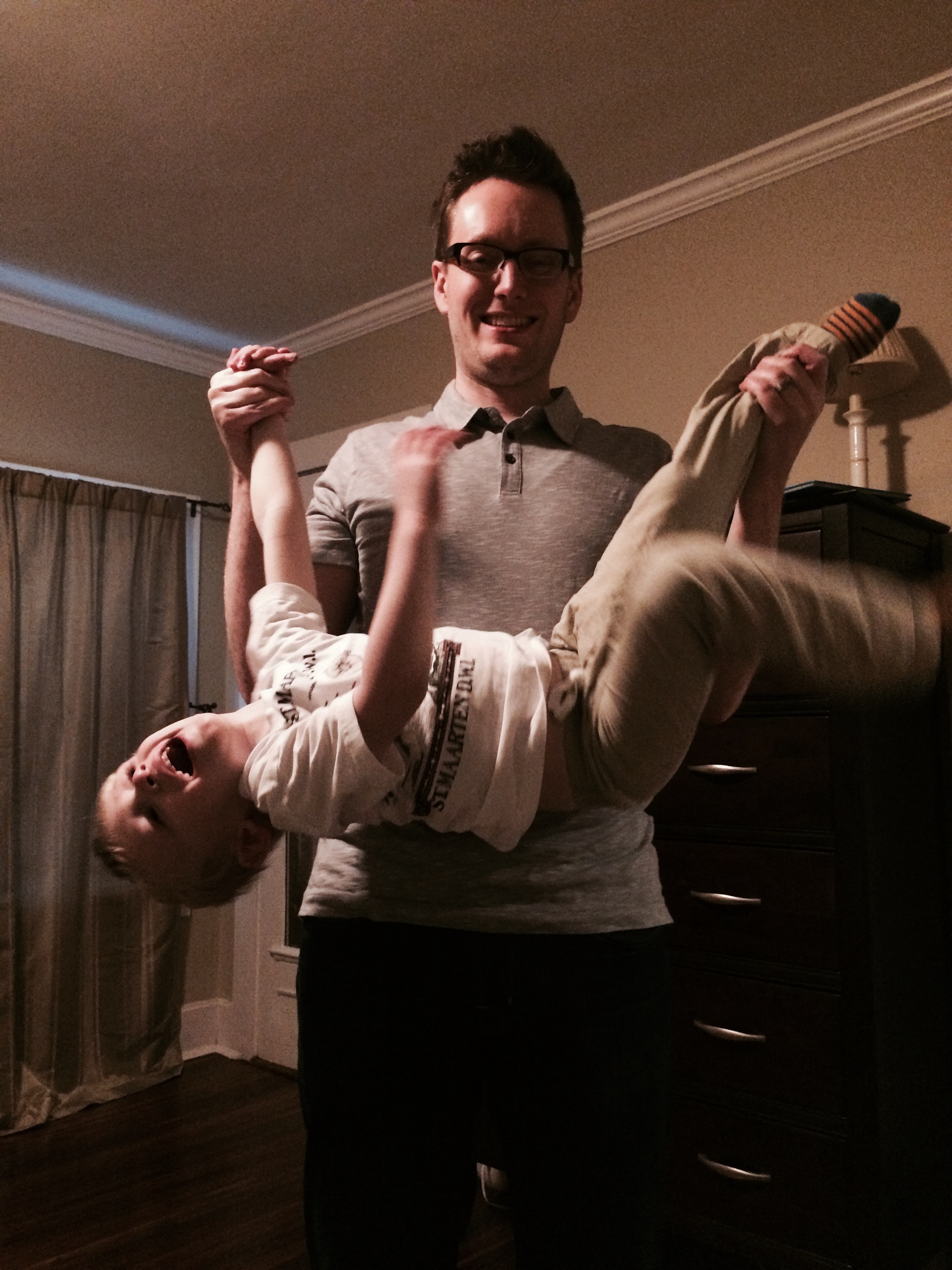 Charlie performing acrobatics with daddy
