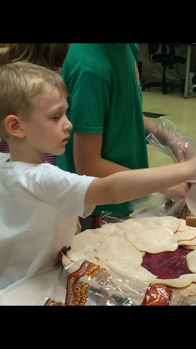 Charlie making sandwiches for the homeless