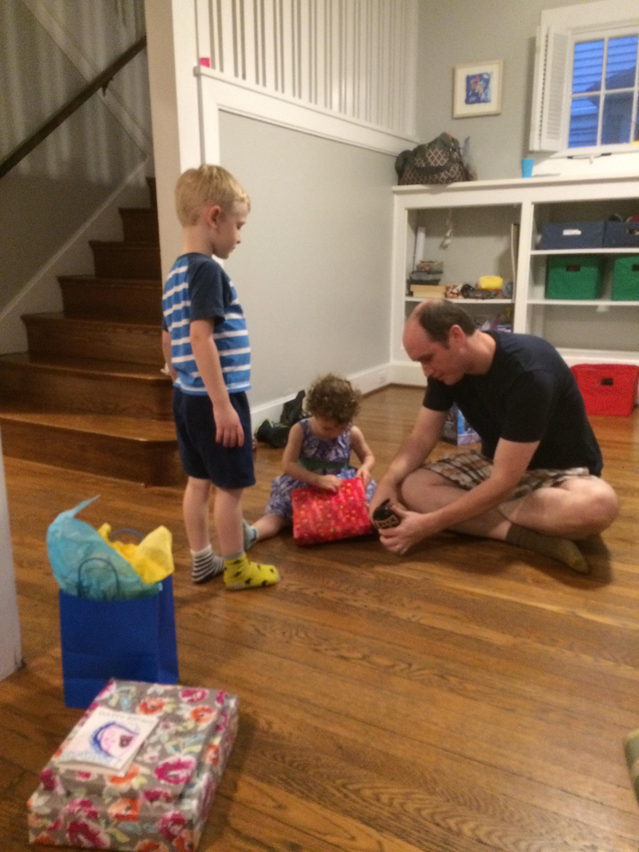 Charlie offered Eleanor one of his presents to open. His idea.