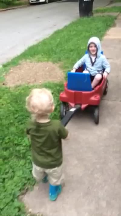 Charlie pulls Andy in wagon